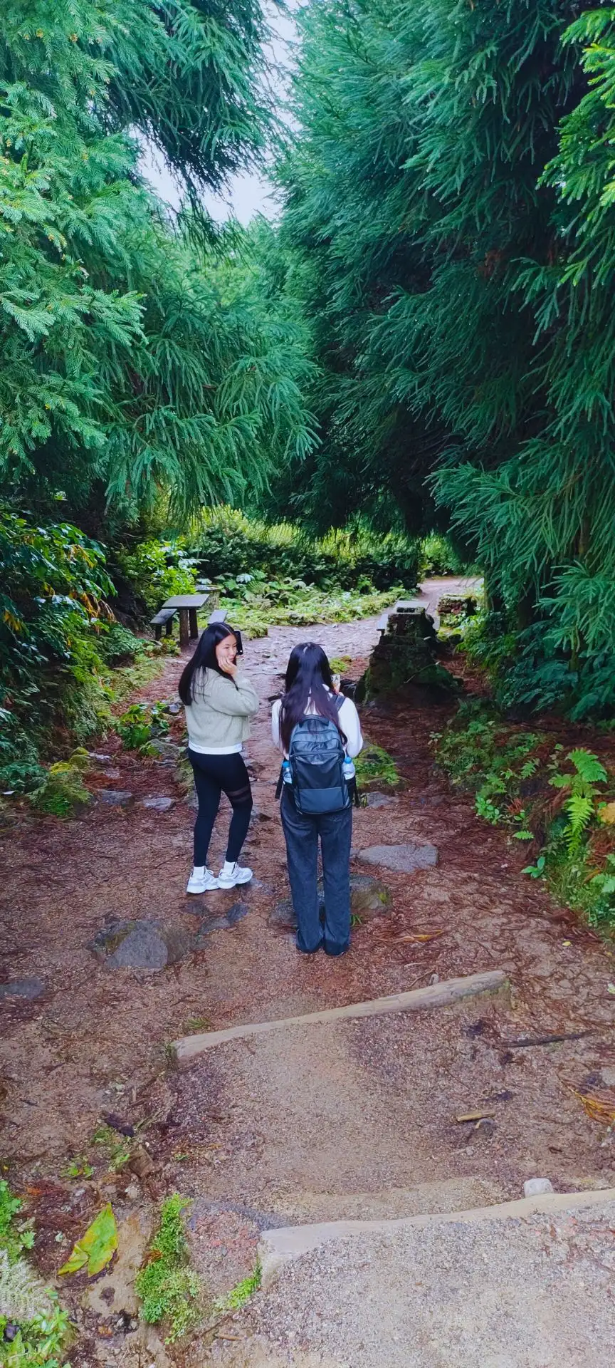Two girls in awe at each other in the middle of nature.