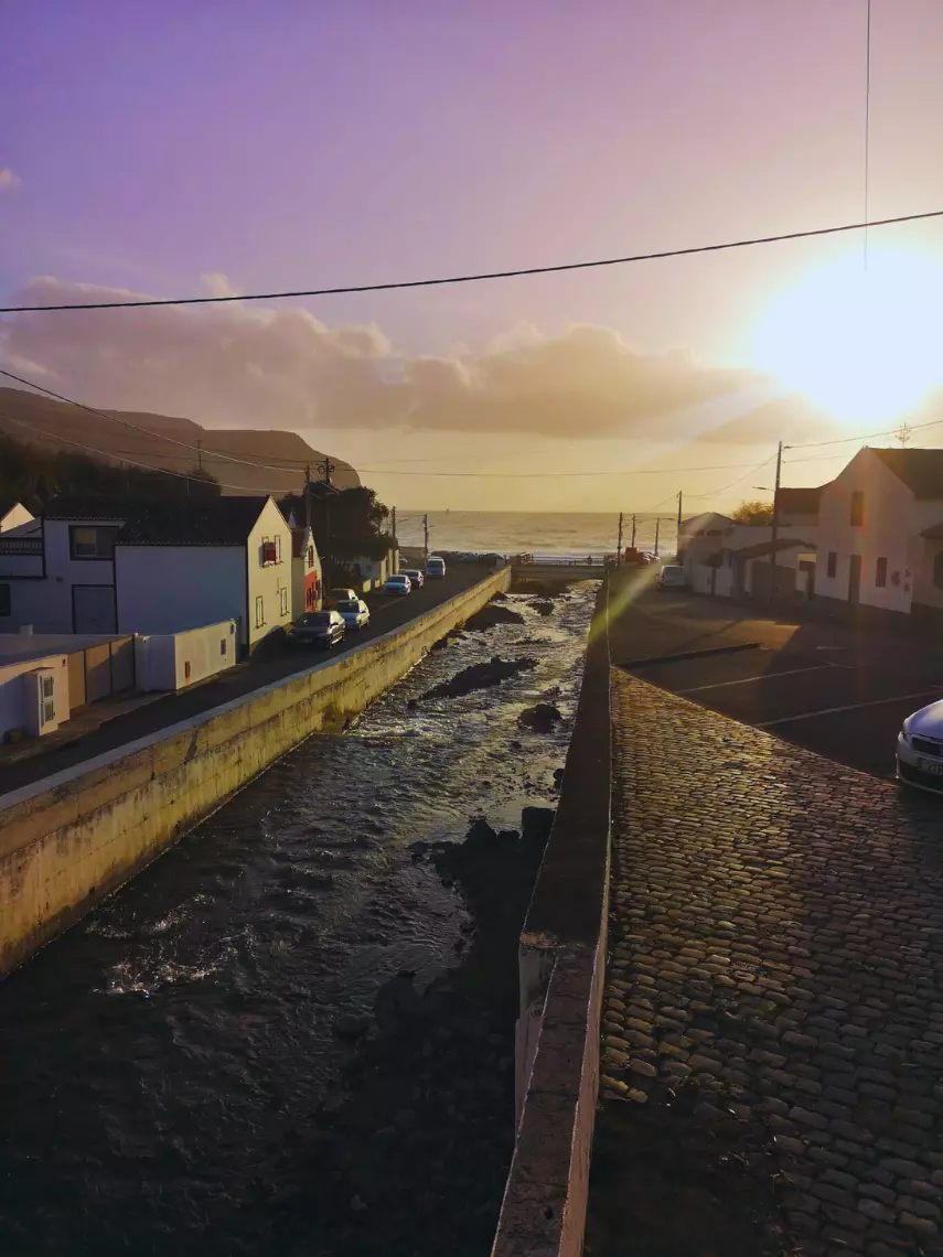A stream of water crossing through a town back to the ocean.